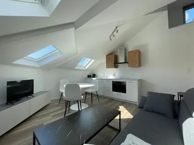 a living room with a couch and a table at Midi Station 3 in Brussels