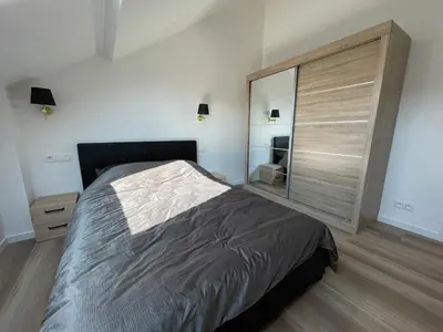 a bedroom with a large bed and a large sliding door at Midi Station 3 in Brussels
