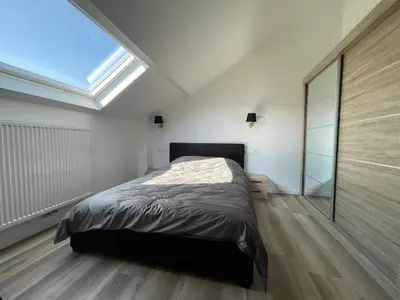 a bedroom with a bed and a skylight at Midi Station 3 in Brussels
