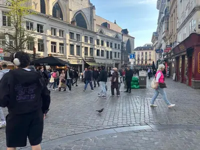a group of people walking down a city street at Charming Studio in Central Brussels - Walk Everywhere! in Brussels