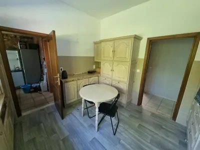 a kitchen with a white table and a table and chairs at Beautiful 4 bedroom Villa close to Antwerp in Zwijndrecht