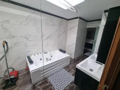 a bathroom with a white tub and a sink at Beautiful 4 bedroom Villa close to Antwerp in Zwijndrecht