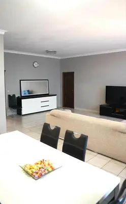 a living room with a couch and a table and chairs at Beautiful 4 bedroom Villa close to Antwerp in Zwijndrecht