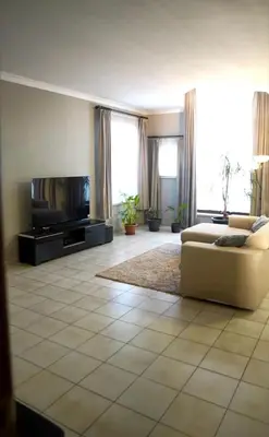 a living room with a couch and a flat screen tv at Beautiful 4 bedroom Villa close to Antwerp in Zwijndrecht