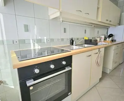 a kitchen with a sink and a stove at Proche du Centre de Bruxelles appartement 5 personnes in Brussels