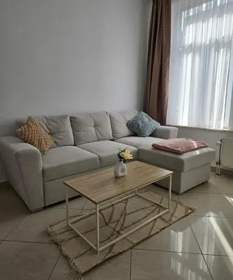 a living room with a couch and a coffee table at Proche du Centre de Bruxelles appartement 5 personnes in Brussels