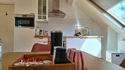 a kitchen with a wooden table with a counter top at Sainte Catherine Apartments in Brussels
