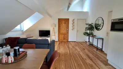 a living room with a blue couch and a table at Sainte Catherine Apartments in Brussels