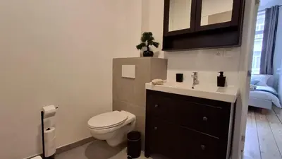 a bathroom with a toilet and a sink at Sainte Catherine Apartments in Brussels