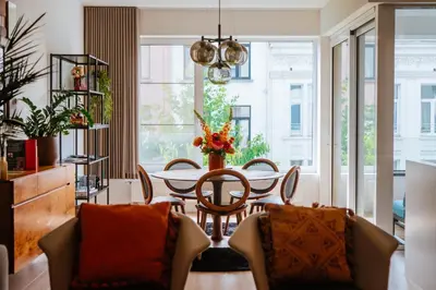 a dining room with a table and chairs at La Petite Foret Design Flat in Antwerp City in Antwerp
