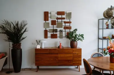 a dining room with a wooden dresser and a table at La Petite Foret Design Flat in Antwerp City in Antwerp
