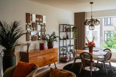 a living room with a table and a dining room at La Petite Foret Design Flat in Antwerp City in Antwerp