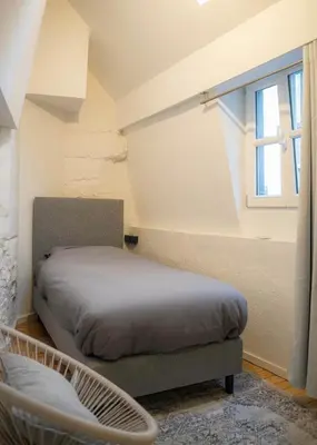a bedroom with a bed and a window at Royal Grand Place Loft in Brussels