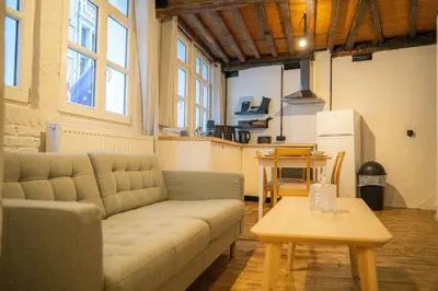 a living room with a couch and a table at Royal Grand Place Loft in Brussels
