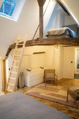 a room with a bunk bed and a ladder at Royal Grand Place Loft in Brussels