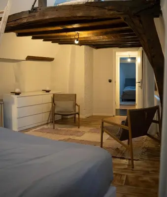 a bedroom with a bed and a desk and chairs at Royal Grand Place Loft in Brussels