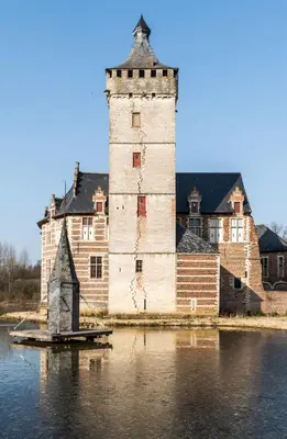 a castle with a tower in the middle of the water at Doris in Tielt