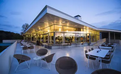 a building with tables and chairs on a roof at Doris in Tielt