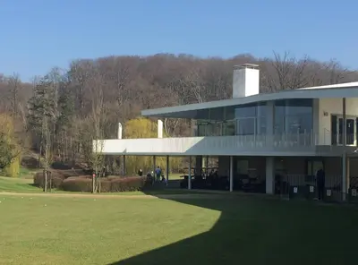 a large building with a grass field in front of it at Doris in Tielt