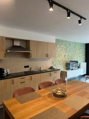 a kitchen with a wooden table and some chairs at Doris in Tielt