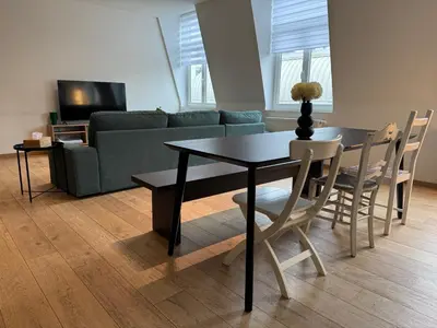 a living room with a table and a couch at Downtown Spacious Design Duplex 3bedR in Brussels