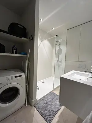a bathroom with a washing machine and a shower at Studio Tzawel in Ghent