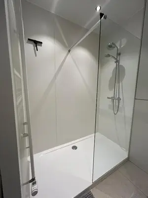 a shower with a glass door in a bathroom at Studio Tzawel in Ghent