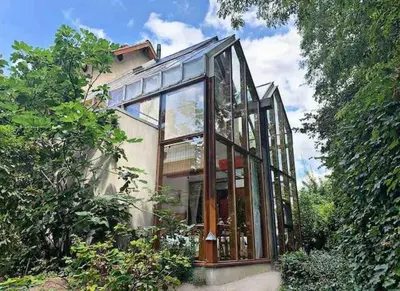 a glass house with a lot of windows at The Bohemian House Melle in Melle