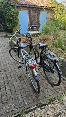 two bikes parked next to each other on a sidewalk at The Bohemian House Melle in Melle