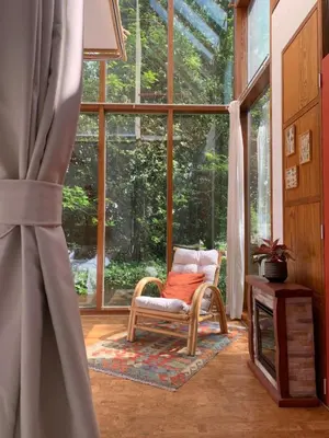 a room with a chair in front of a large window at The Bohemian House Melle in Melle