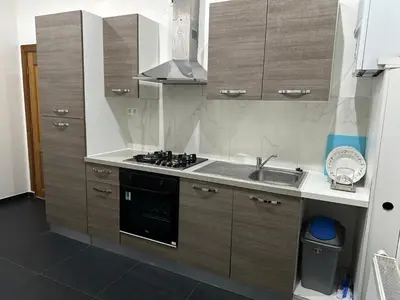 a kitchen with a sink and a stove at Sweet apartment with belcon in Brussels