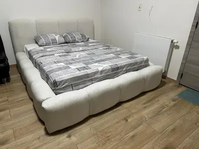 a bed in a room with a couch with pillows at Sweet apartment with belcon in Brussels