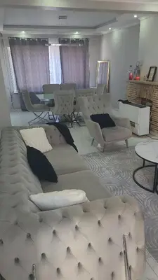 a living room with a couch and chairs and a table at Une Maison chaleureuse in Lebbeke