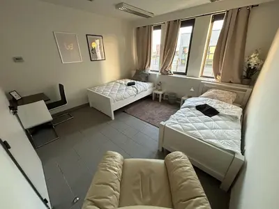 a living room with two beds and a couch at Stay Here in Erpe-Mere