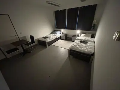 a living room with two beds and a couch at Stay Here in Erpe-Mere