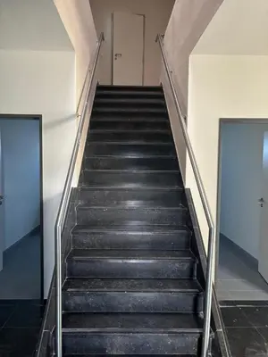 a staircase in a building with two doors at Stay Here in Erpe-Mere