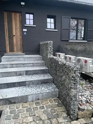a house with stairs leading to a front door at La maison de Nikolas in Oosterzele