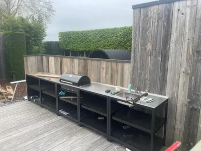 a desk with a sink on a wooden deck at La maison de Nikolas in Oosterzele