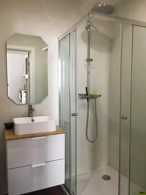 a bathroom with a glass shower and a sink at Charming studio in the heart of Saint-Gilles in Brussels