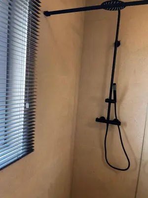 a shower in a bathroom with a shower at Appartement ' Tintin Travels' in Geel