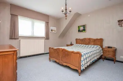 a bedroom with a wooden bed and a window at Tomorrowland Belgium 2025 house Antwerp in Edegem
