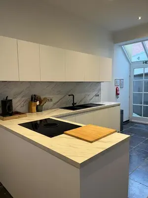 a kitchen with a sink and a counter top at Sint-Catharina in Lier