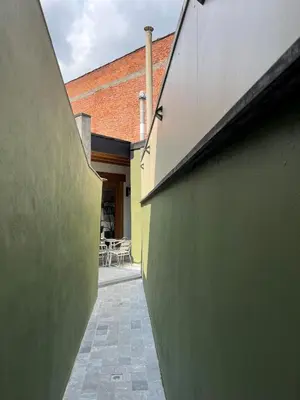 a hallway of a house with a wall and a table at Sint-Catharina in Lier