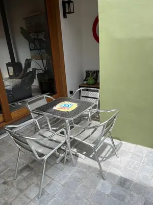 a table and chairs in a living room with a table at Sint-Catharina in Lier