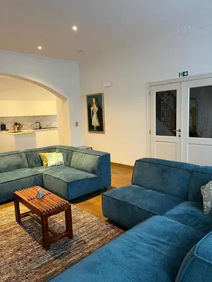a living room with two blue couches and a coffee table at Sint-Catharina in Lier