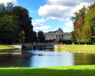 a large building with a bridge over a river at Hyggehus Tervuren in Tervuren
