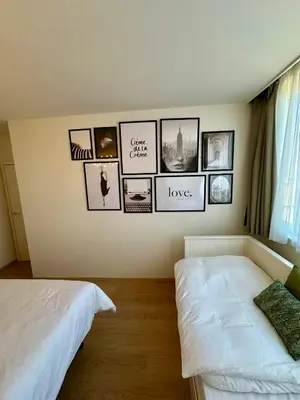 a bedroom with two beds and pictures on the wall at Penthouse Grand Place - 2bd - 200sqm Terrace in Brussels
