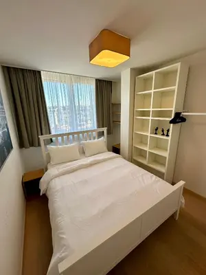 a bedroom with a white bed and a window at Penthouse Grand Place - 2bd - 200sqm Terrace in Brussels