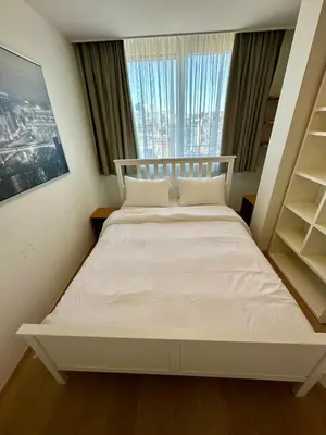 a white bed in a room with a window at Penthouse Grand Place - 2bd - 200sqm Terrace in Brussels