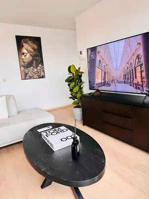 a living room with a coffee table and a flat screen tv at Grand Place View - 2bd - Exclusive Apartment in Brussels